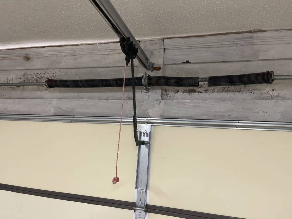 Broken garage door torsion spring before replacement