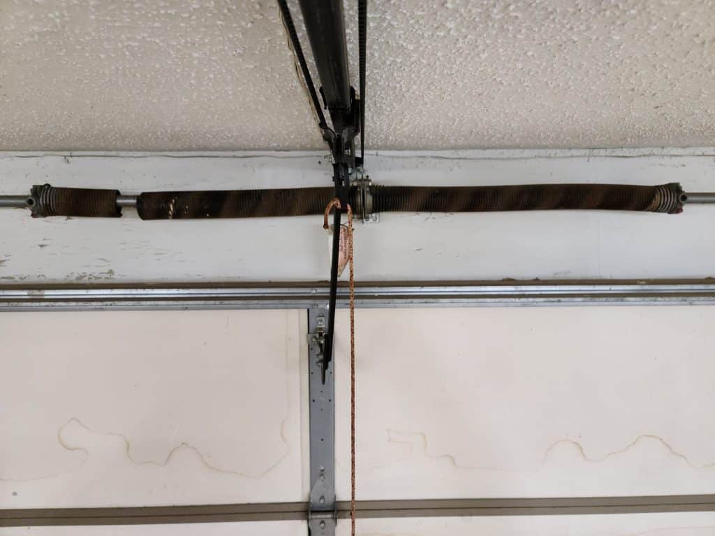 Broken rusted garage door spring