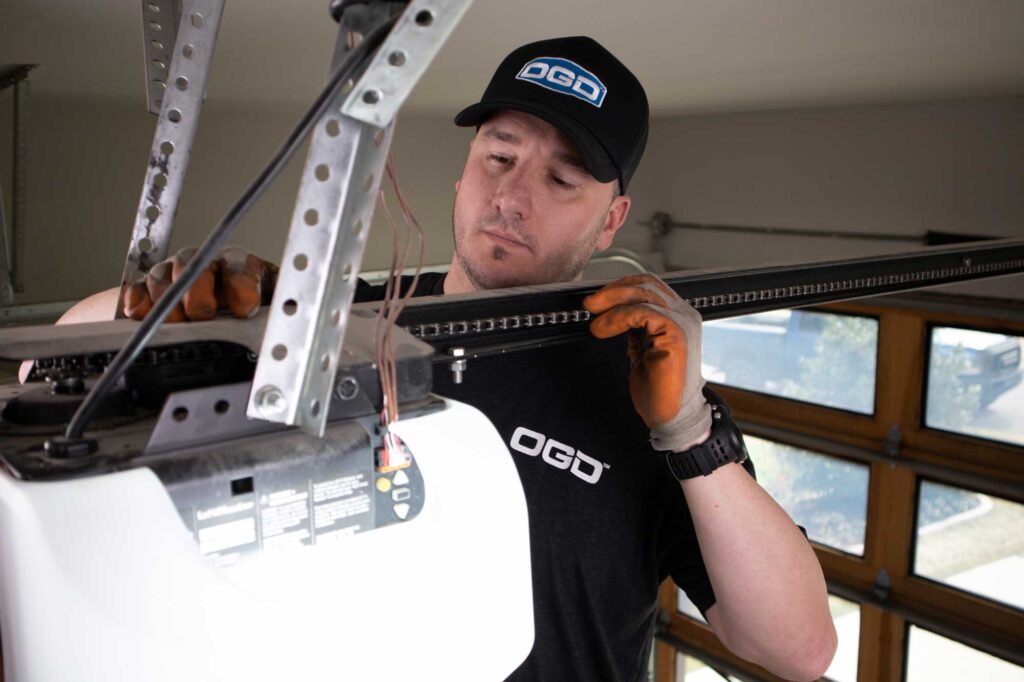 Image of a tech repairing a garage door opener