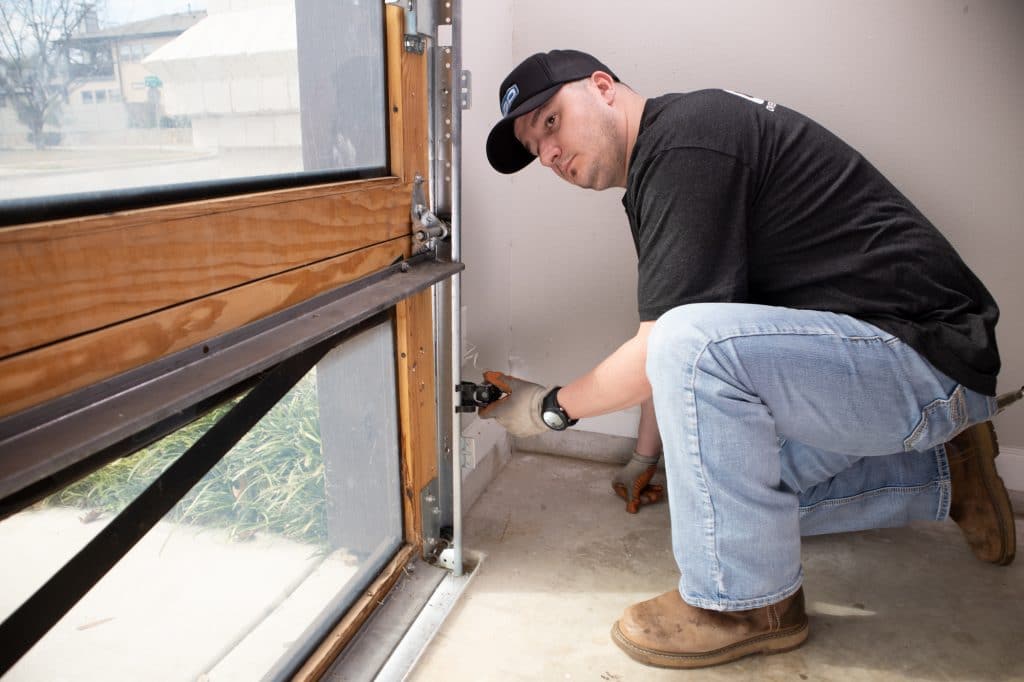 Garage door technician performs a garage door repair