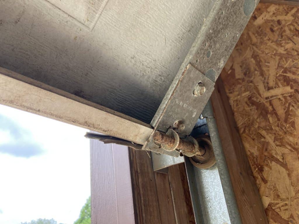 Rusted garage door roller needing replacement